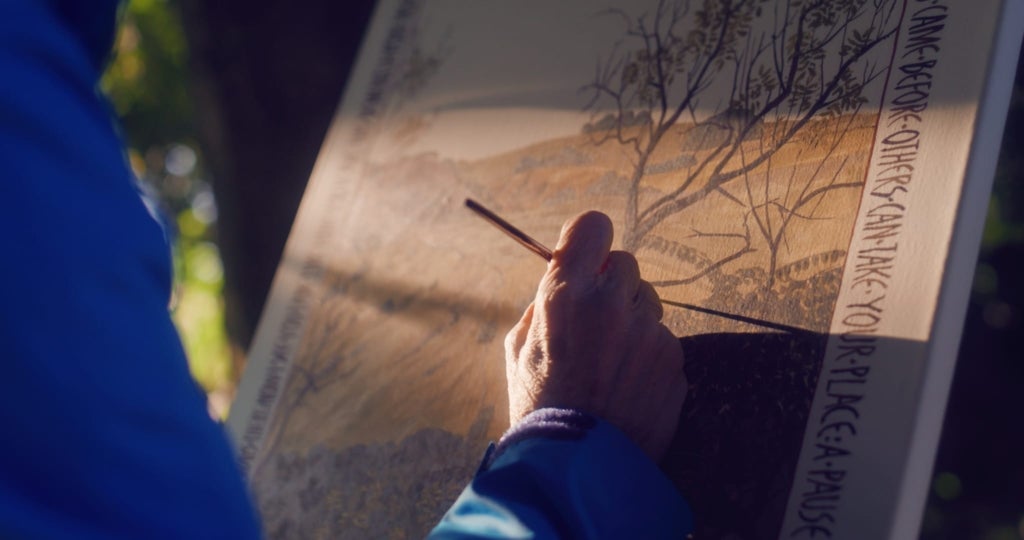Taken over the shoulder of the painter while at work, this image shows Prince's hand as she delicately paints a landscape for the LIFE in the Ravines project.