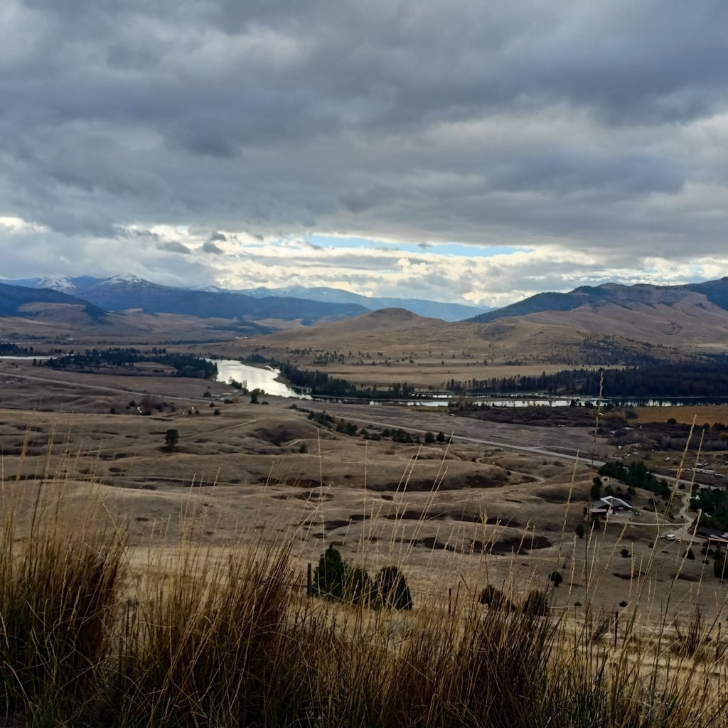 A mosaic landscape Bison Range in Montana stretches out under a cloudy sky.